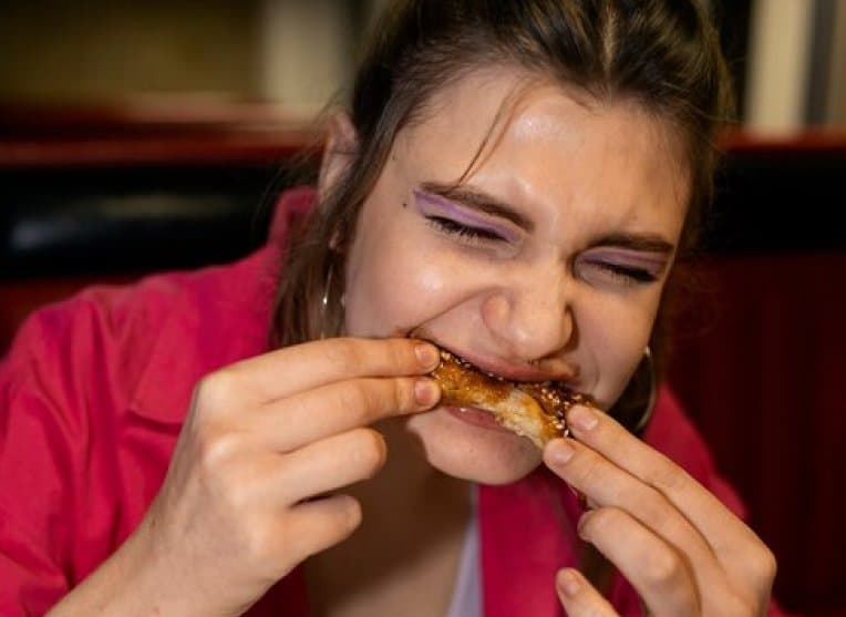 Guest taking a big bite of a wing